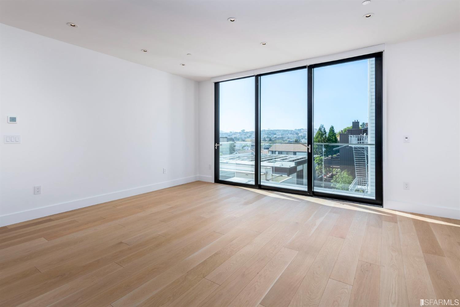 1805 Buchanan Street, Unit 3B San Francisco, CA 94115 - Photo 40 of 55 a view of an empty room with wooden floor and a window