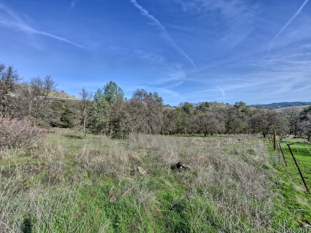 668 Murphys Grade Road Angels Camp, CA 95222 - Photo 11 of 30 a view of a lake with a mountain in the background