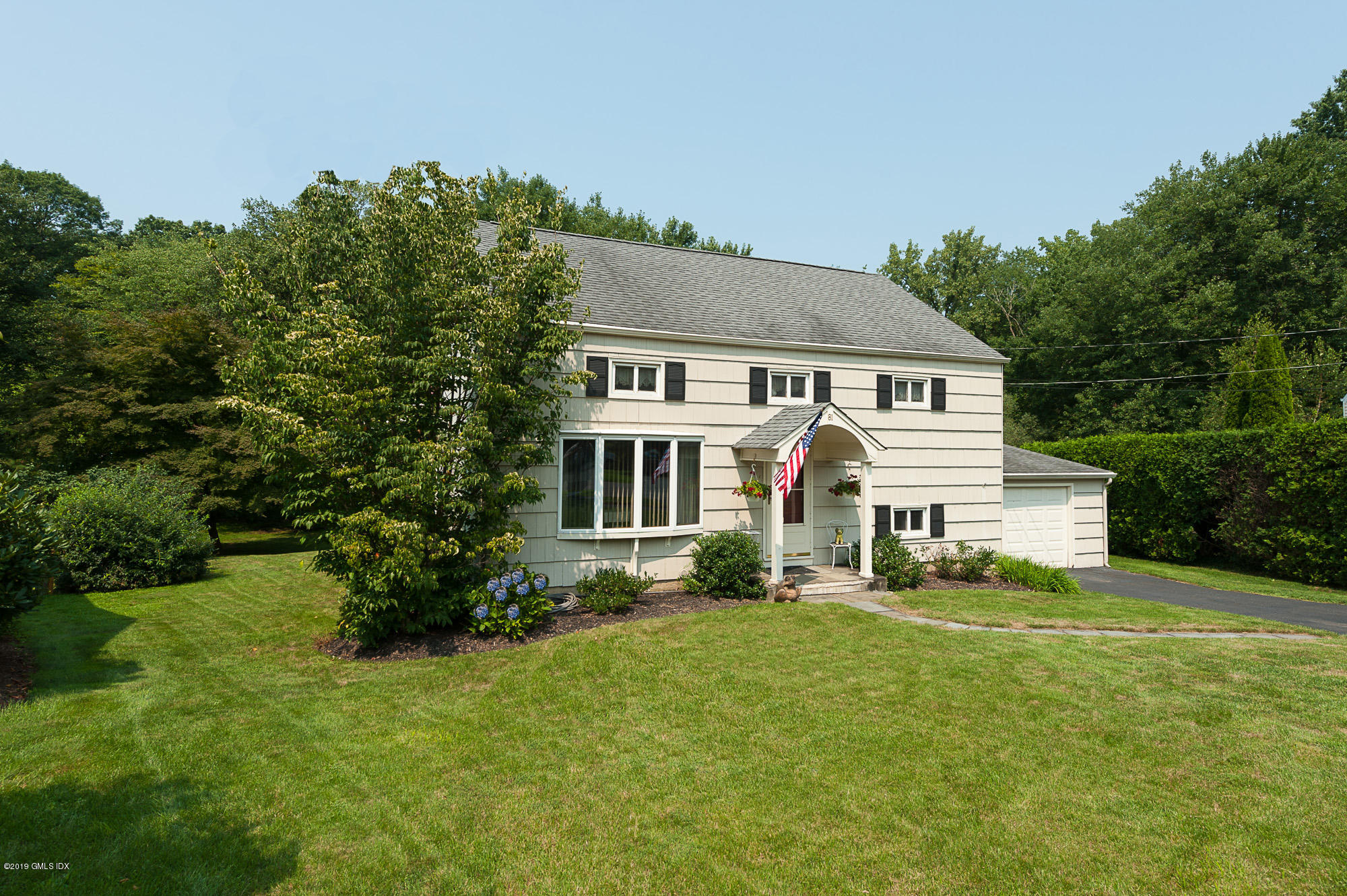 81 Mary Lane Riverside, CT 06878 - Photo 1 of 26 a front view of a house with a yard