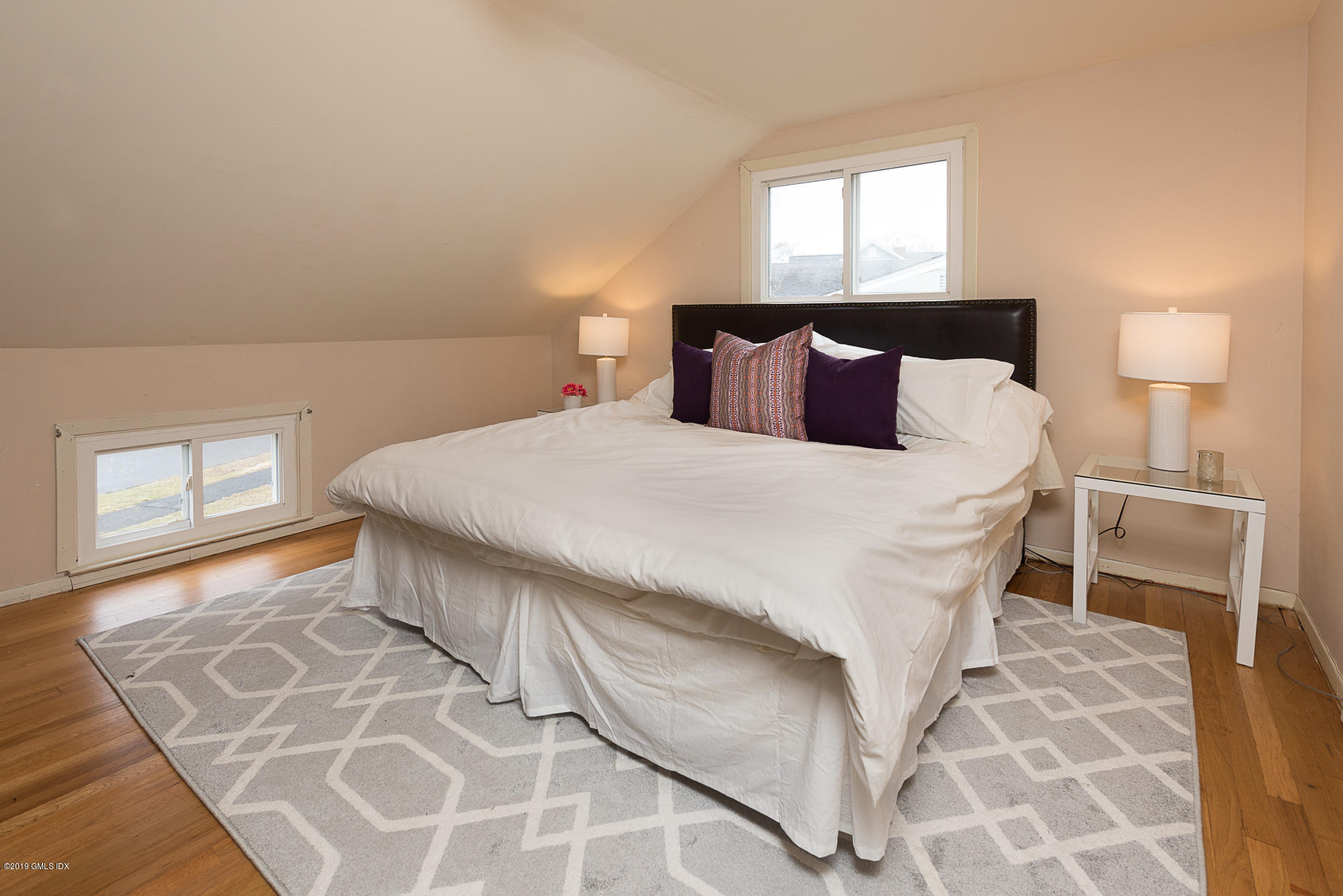 81 Mary Lane Riverside, CT 06878 - Photo 15 of 26 a bedroom with a bed and wooden floor