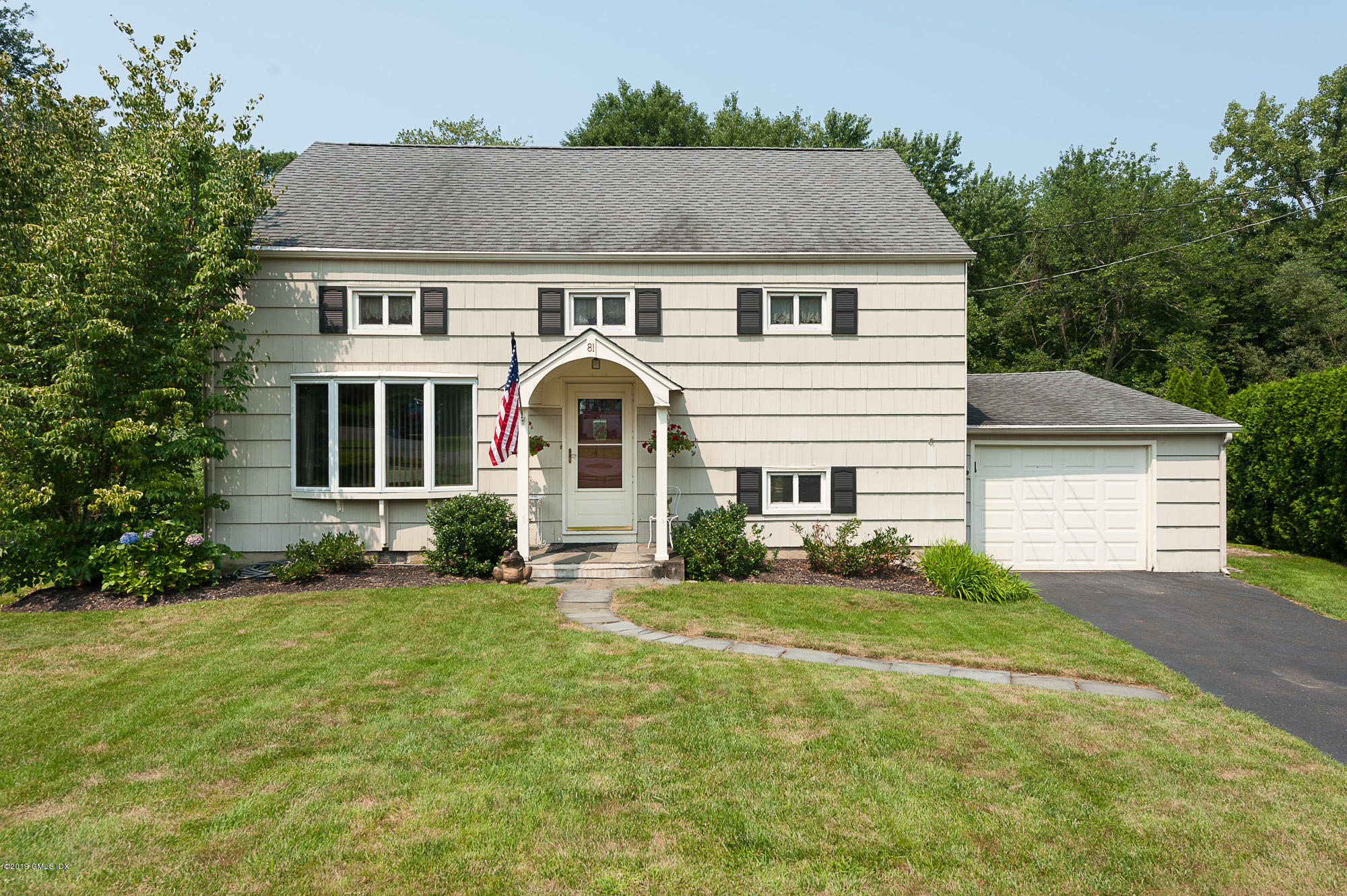 81 Mary Lane Riverside, CT 06878 - Photo 2 of 26 a front view of a house with a yard