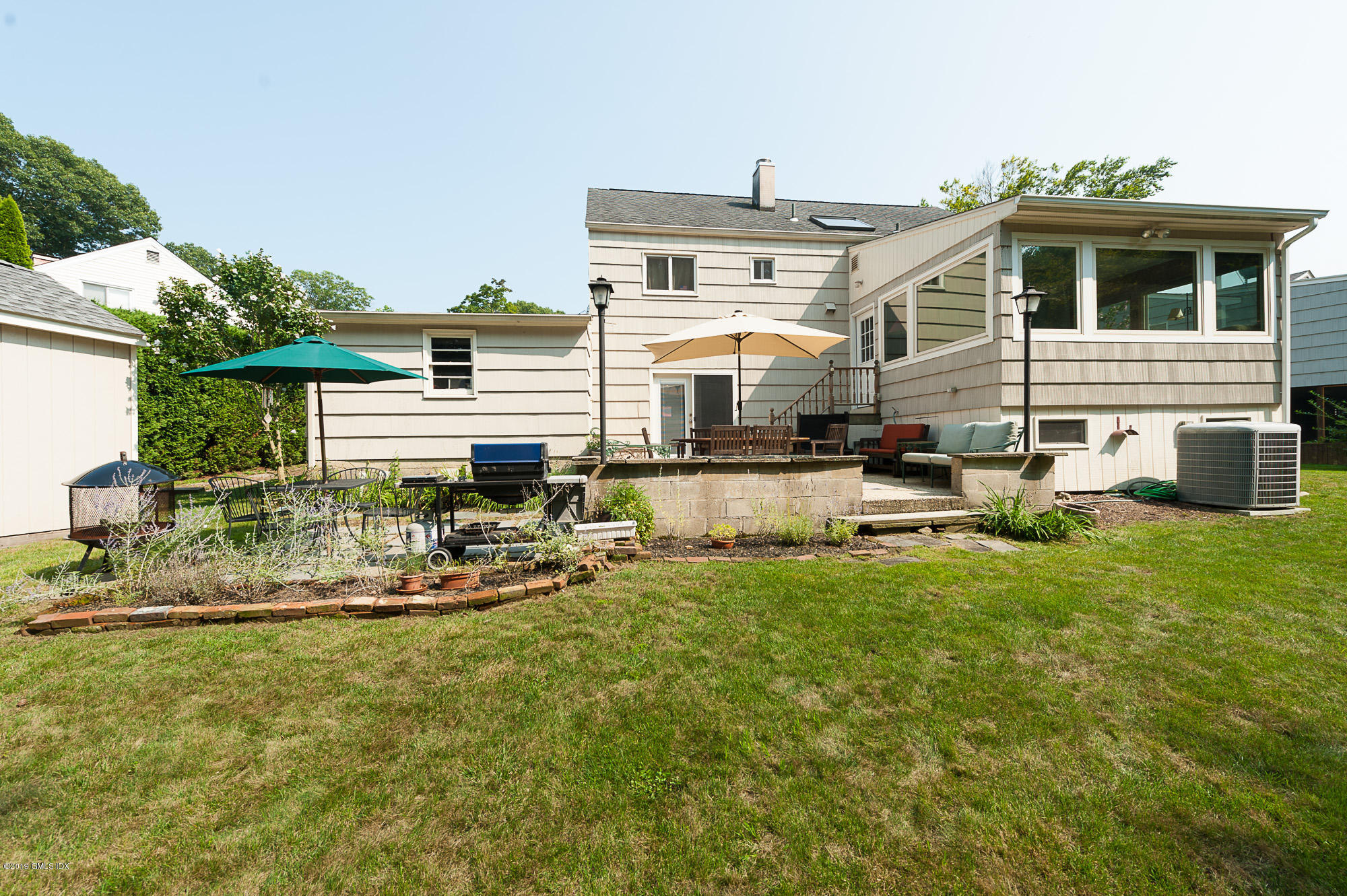 81 Mary Lane Riverside, CT 06878 - Photo 22 of 26 a front view of a house with swimming pool