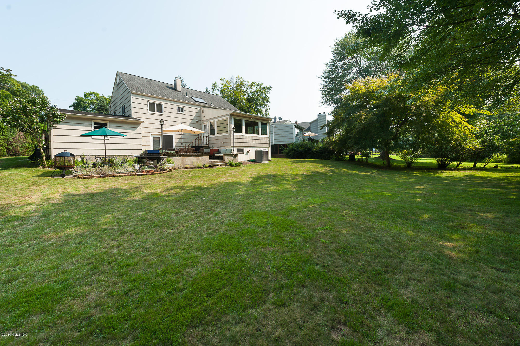 81 Mary Lane Riverside, CT 06878 - Photo 23 of 26 a front view of house with yard and trees