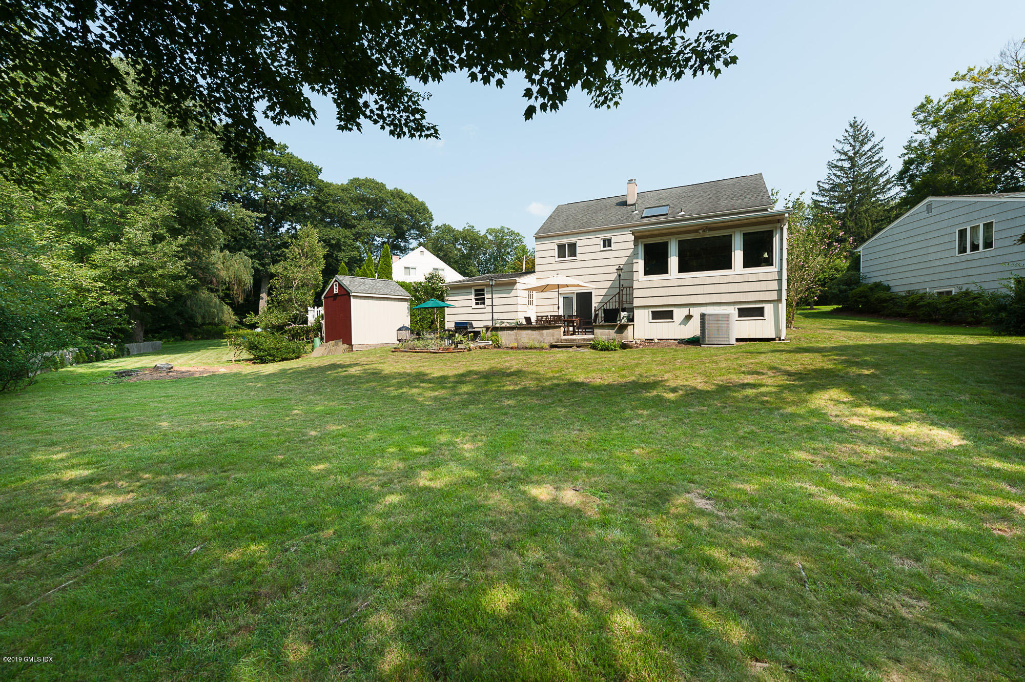 81 Mary Lane Riverside, CT 06878 - Photo 24 of 26 a front view of a house with garden