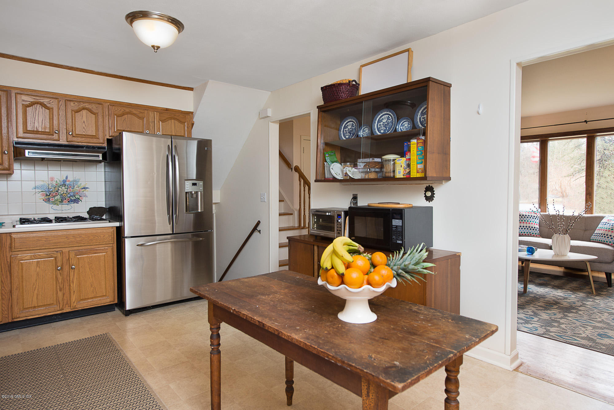 81 Mary Lane Riverside, CT 06878 - Photo 10 of 26 a kitchen with stainless steel appliances granite countertop a refrigerator a stove and a sink with couches