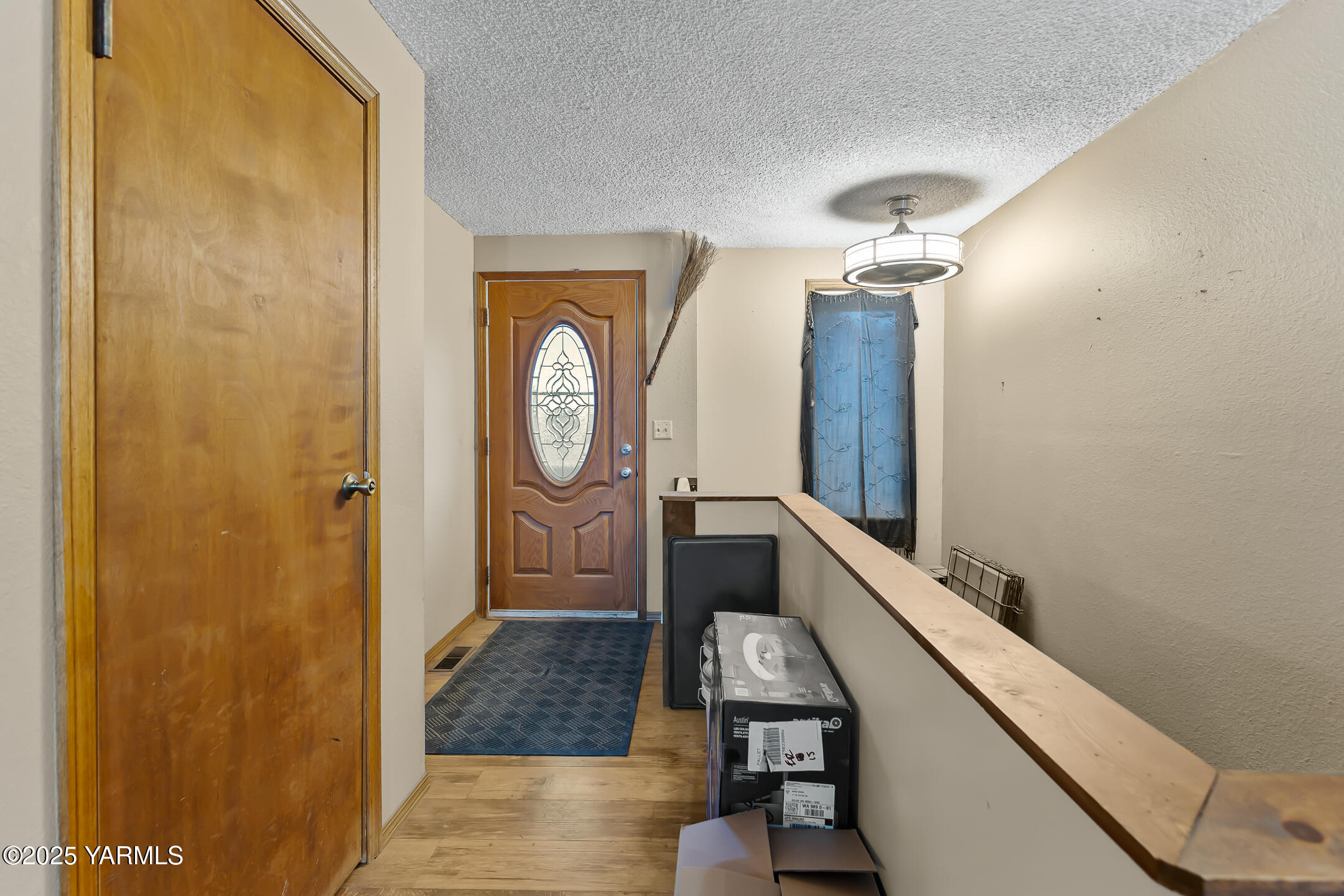 171 West Taylor Road Selah, WA 98942 - Photo 15 of 37 a view of a hallway with entryway wooden floor and front door