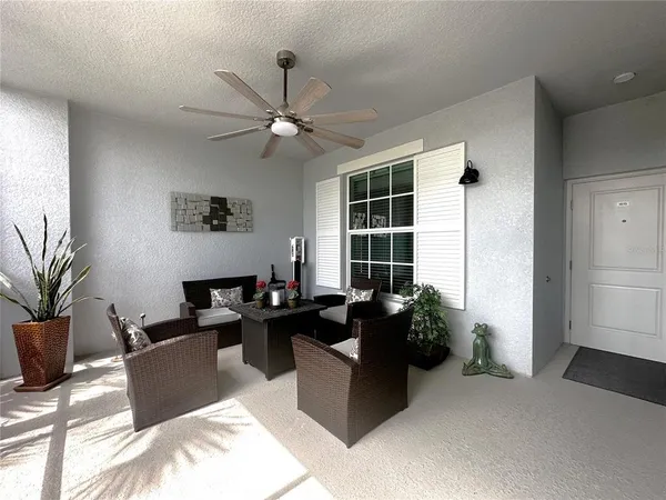 a large living room with stainless steel appliances kitchen island granite countertop couches and a flat screen tv