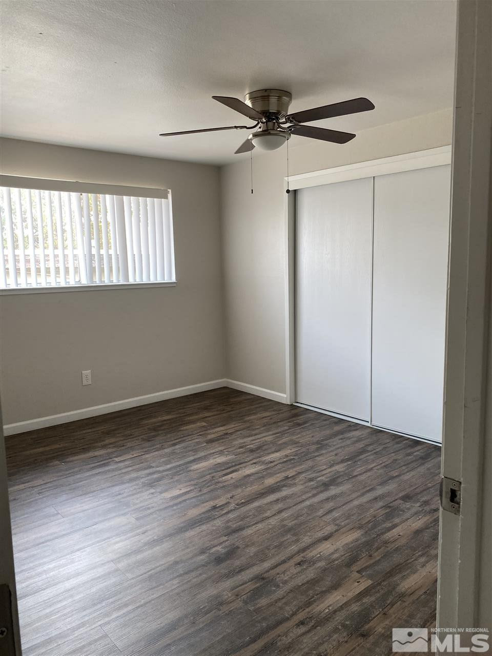 1365 Stardust Street, Unit 3 Reno, NV 89503 - Photo 4 of 9 a view of an empty room with a window and wooden floor
