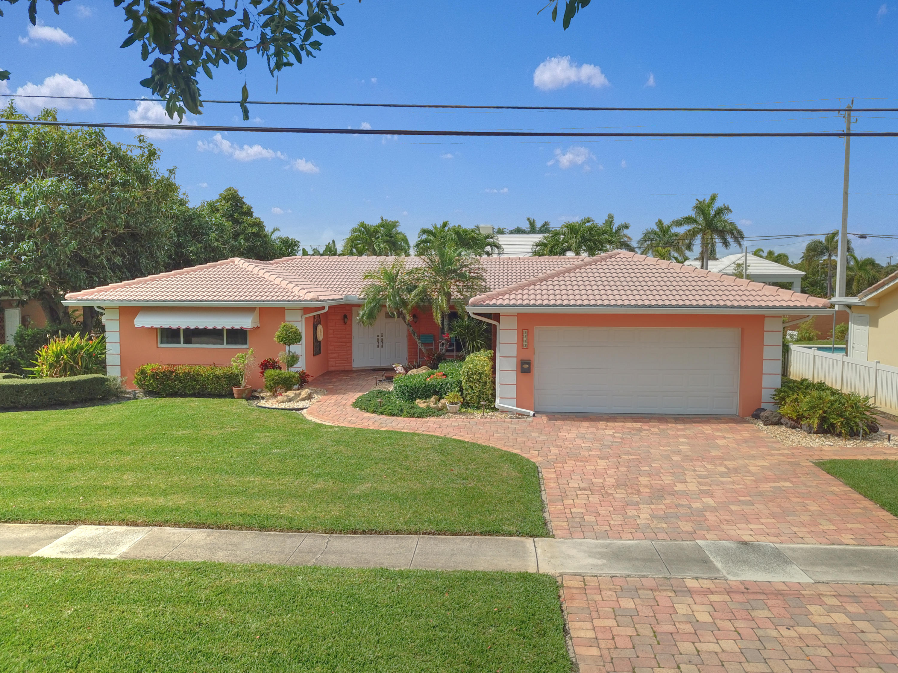 3533 Northeast 6th Drive Boca Raton, FL 33431 - Photo 1 of 23 a front view of a house with a yard and garage