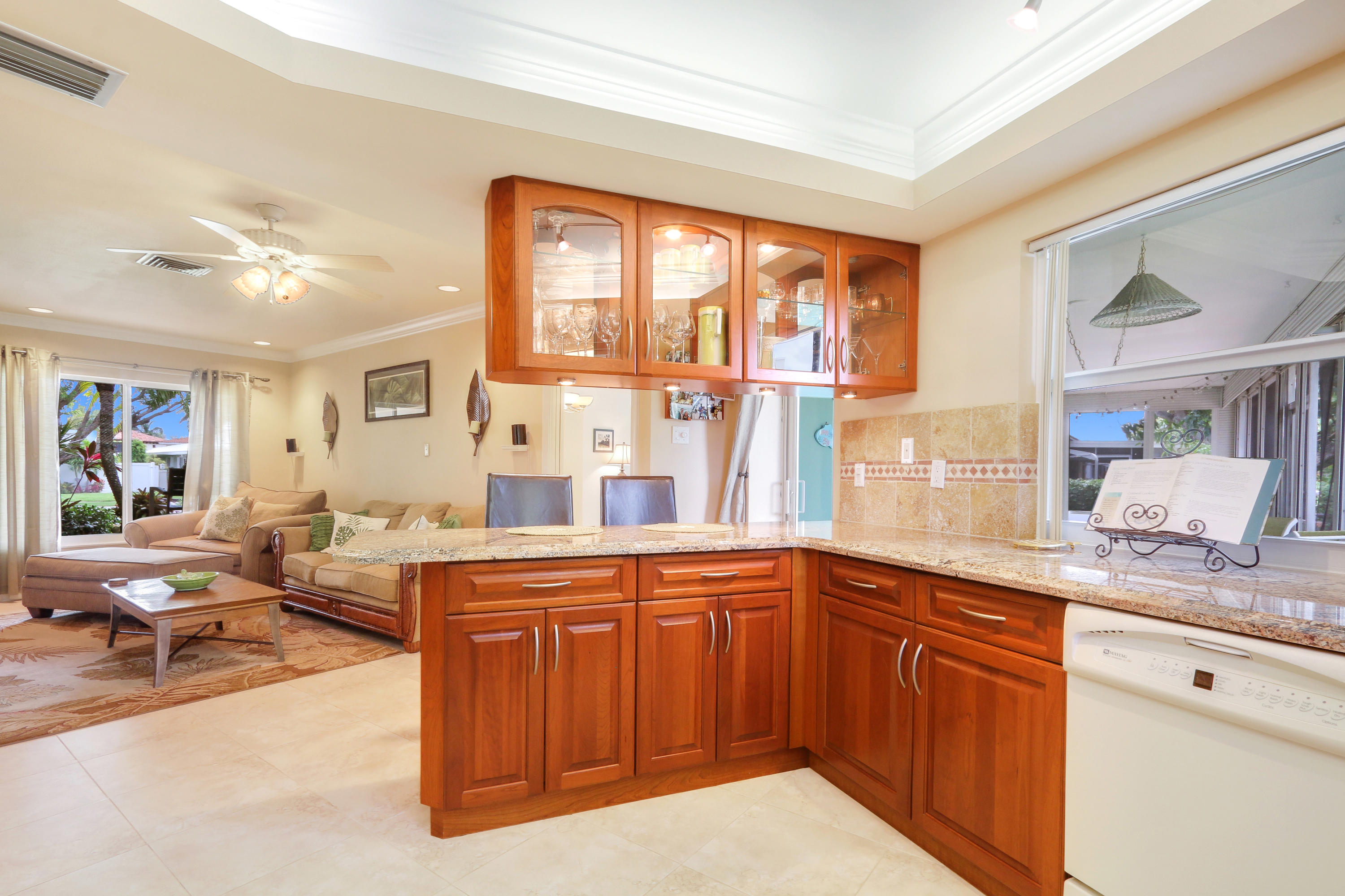 3533 Northeast 6th Drive Boca Raton, FL 33431 - Photo 11 of 23 a large kitchen with a large window and wooden cabinets