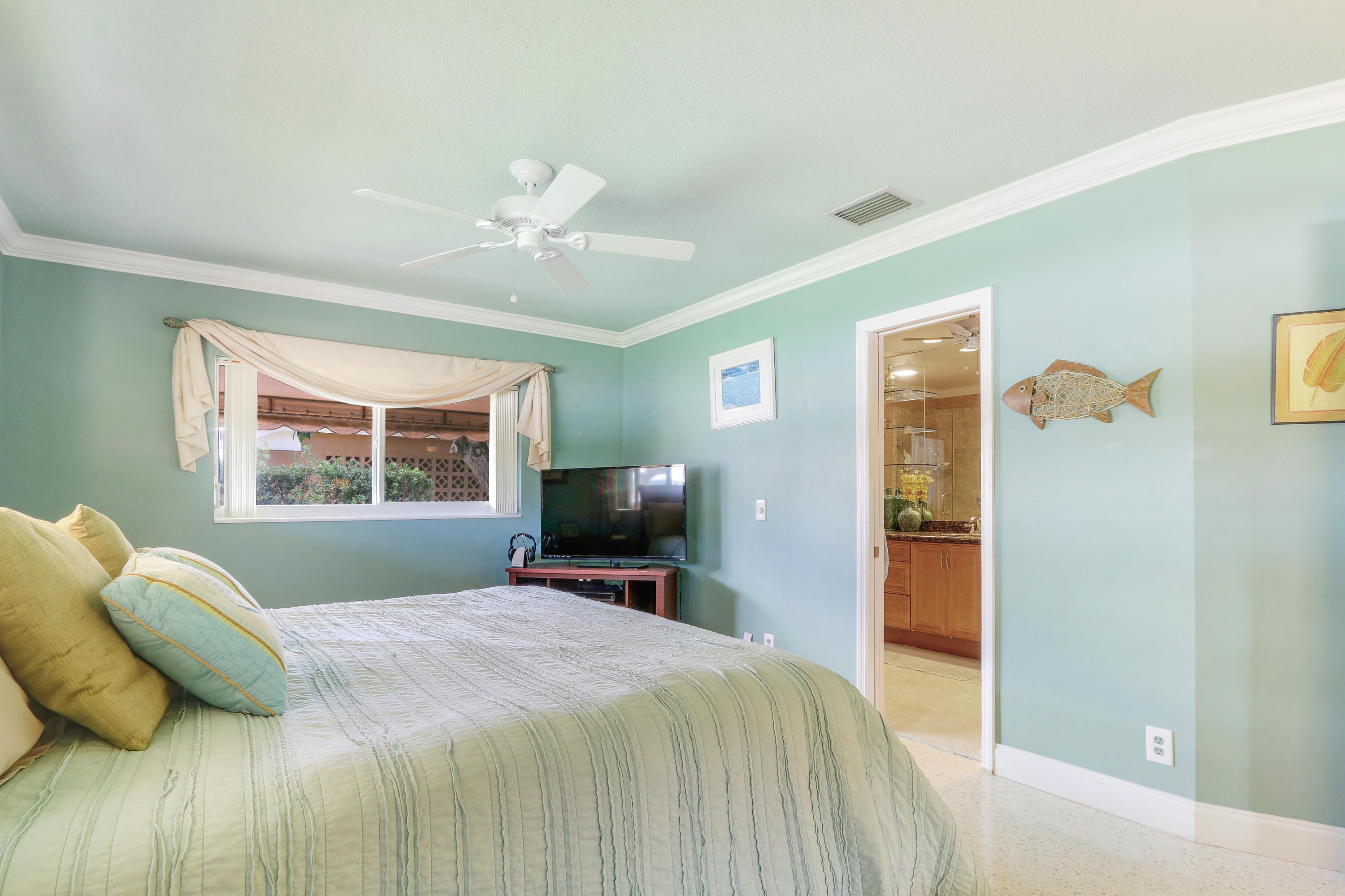 3533 Northeast 6th Drive Boca Raton, FL 33431 - Photo 15 of 23 a bedroom with a bed and a flat screen tv
