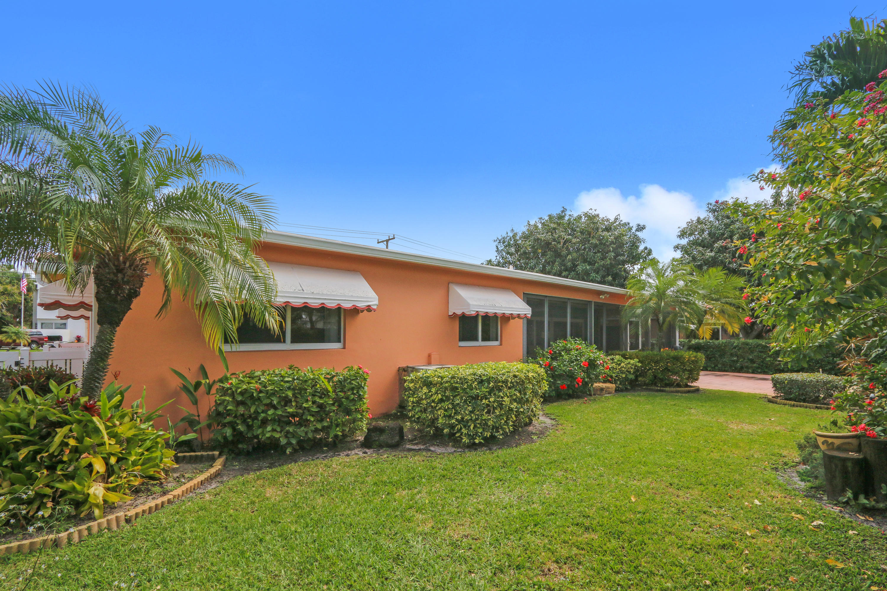 3533 Northeast 6th Drive Boca Raton, FL 33431 - Photo 22 of 23 a front view of a house with garden