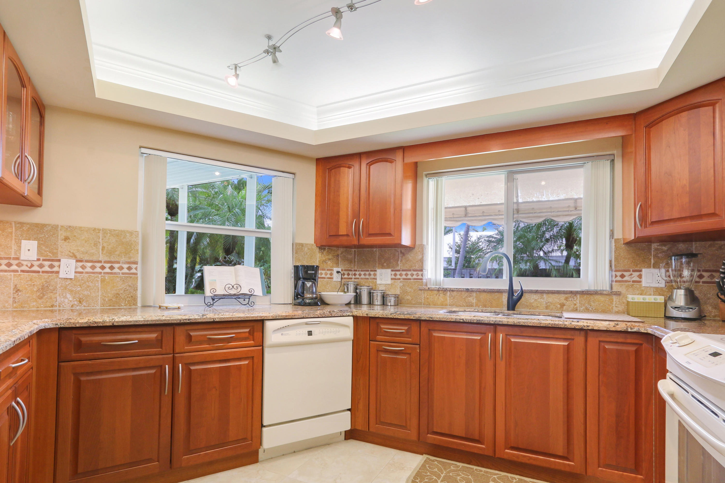 3533 Northeast 6th Drive Boca Raton, FL 33431 - Photo 9 of 23 a kitchen with granite countertop a sink window and cabinets