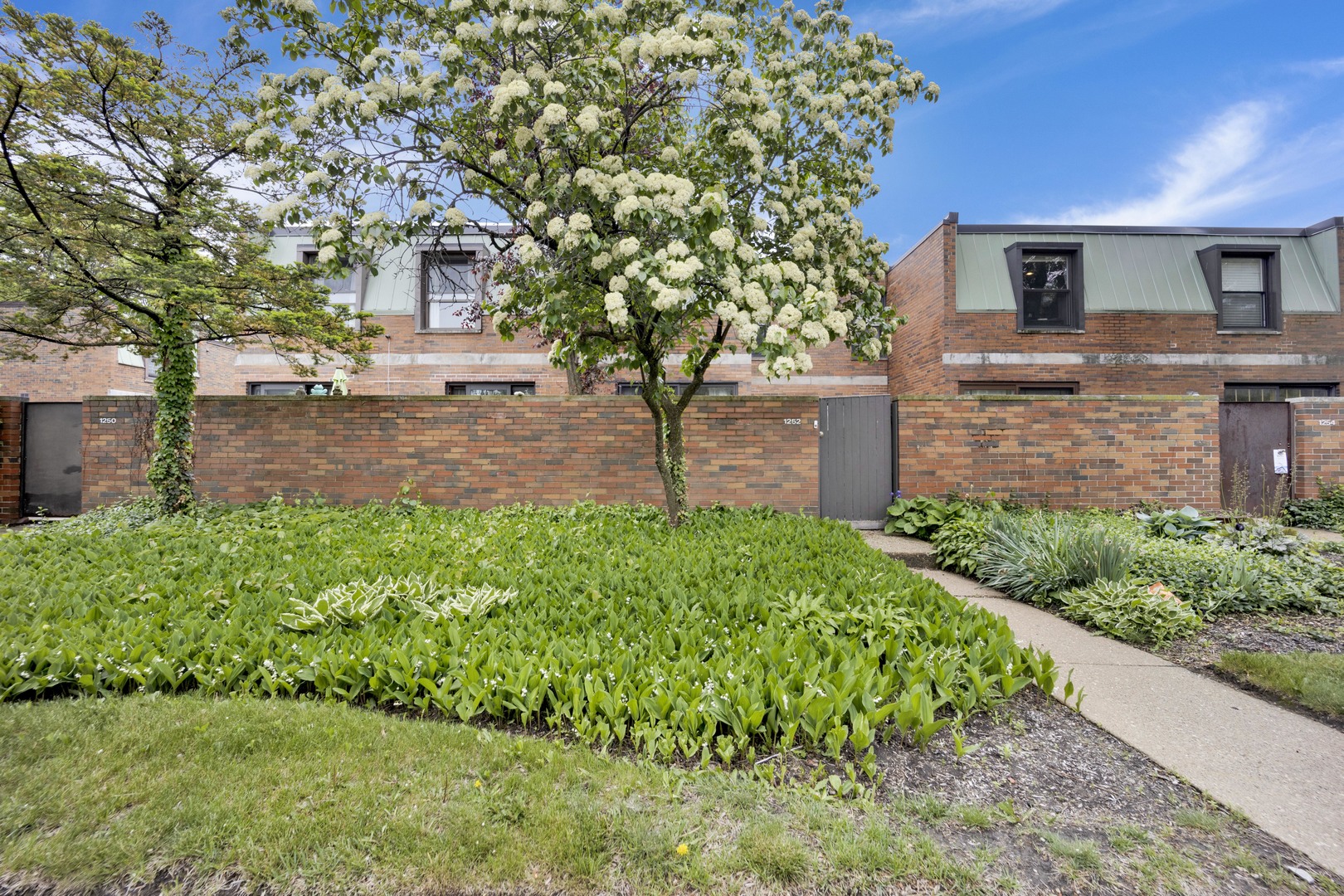 1252 West Westgate Terrace Chicago, IL 60607 - Photo 20 of 24 a front view of a house with a yard