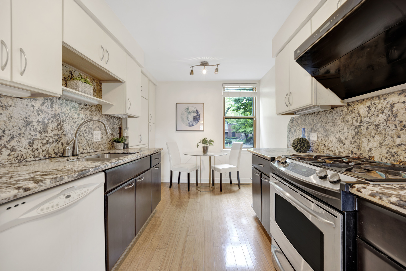 1252 West Westgate Terrace Chicago, IL 60607 - Photo 7 of 24 a kitchen with stainless steel appliances a stove a sink and a microwave