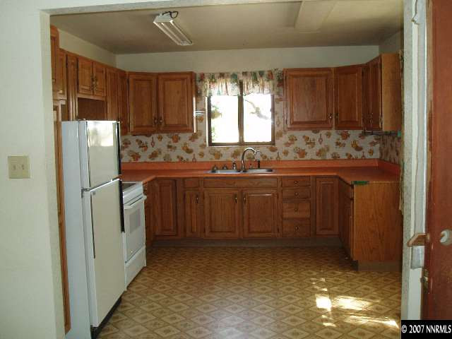 7250 Reno Highway Fallon, NV 89406 - Photo 2 of 6 a kitchen with a sink refrigerator and window