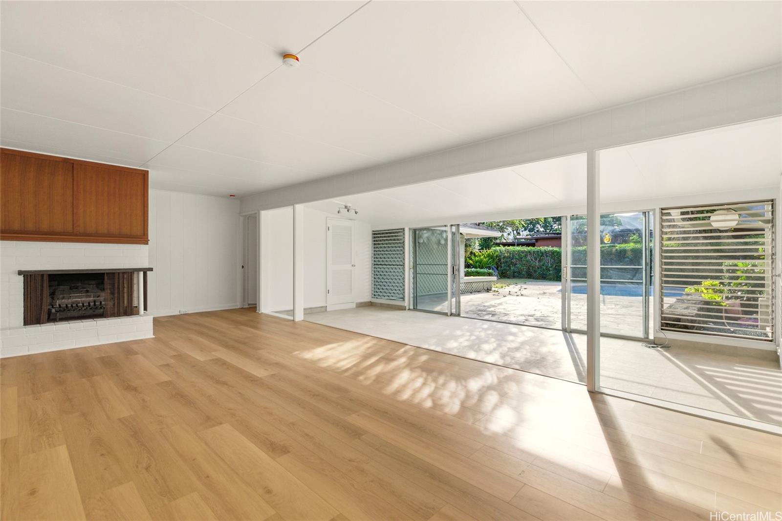 845 North Kalaheo Avenue Kailua, HI 96734 - Photo 4 of 18 a view of an empty room with a fireplace and a window