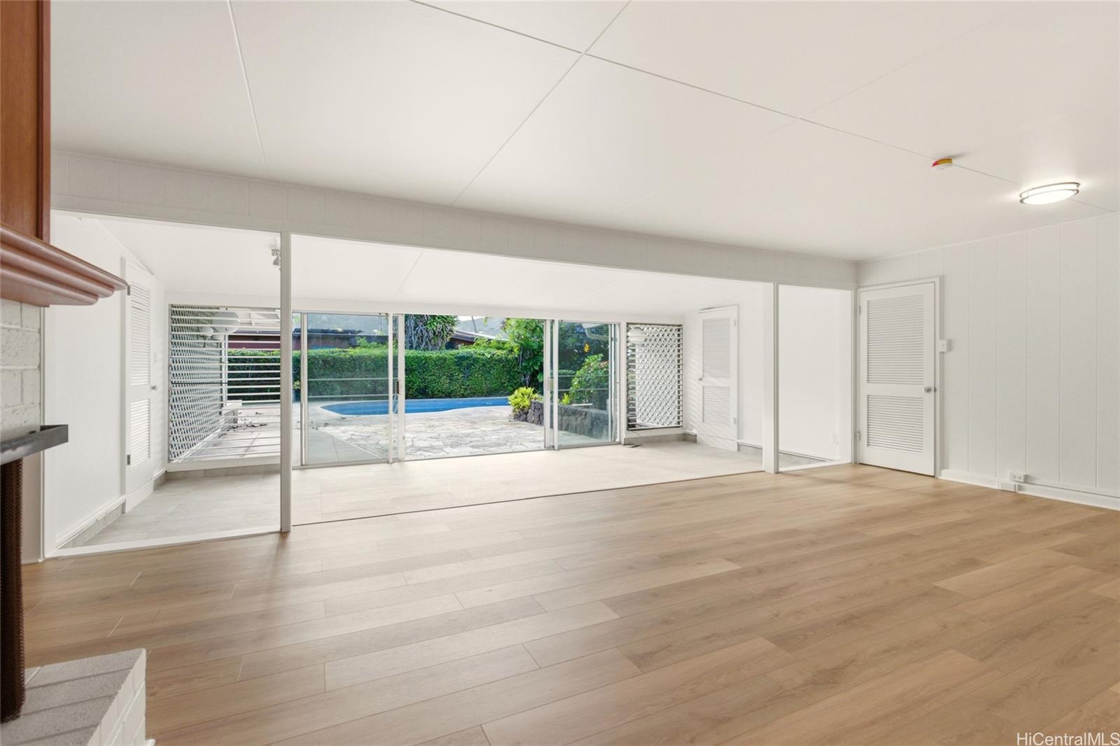 845 North Kalaheo Avenue Kailua, HI 96734 - Photo 6 of 18 a view of an empty room with wooden floor and windows