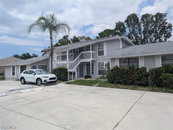 a view of house with outdoor space and parking
