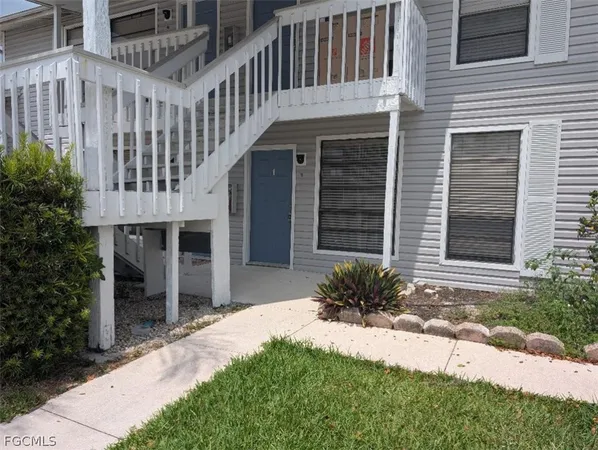 a front view of a house with a yard and outdoor seating