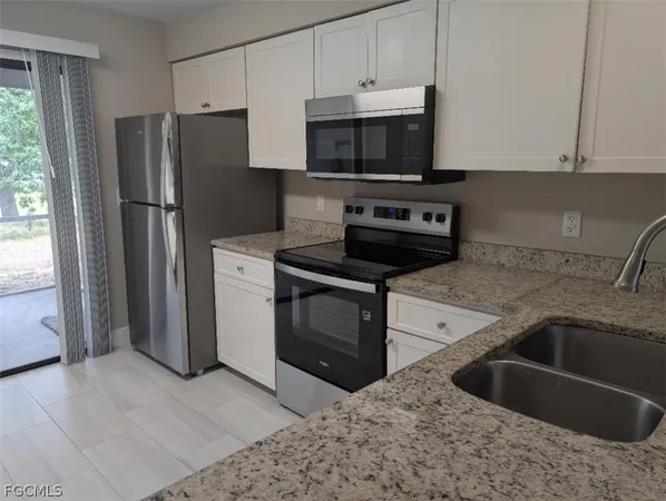 a kitchen with a sink stove and refrigerator