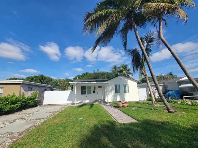 front view of a house with a garden