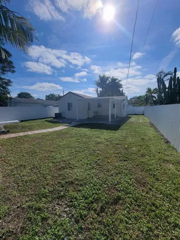 a view of a backyard with sitting area