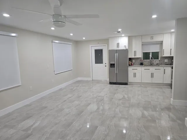 a view of kitchen with refrigerator oven and stove