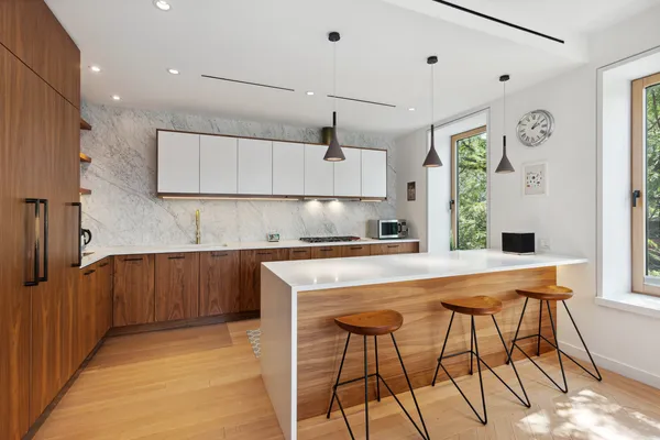 a kitchen with stainless steel appliances kitchen island granite countertop a table and chairs