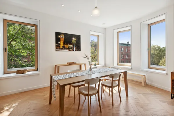 a kitchen with a table chairs refrigerator and microwave
