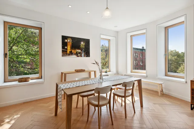 a kitchen with a table chairs refrigerator and microwave
