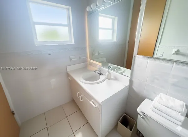 a man standing on a beach next to a yard