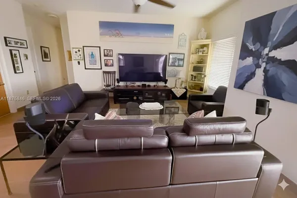 a dining room with furniture a chandelier and wooden floor