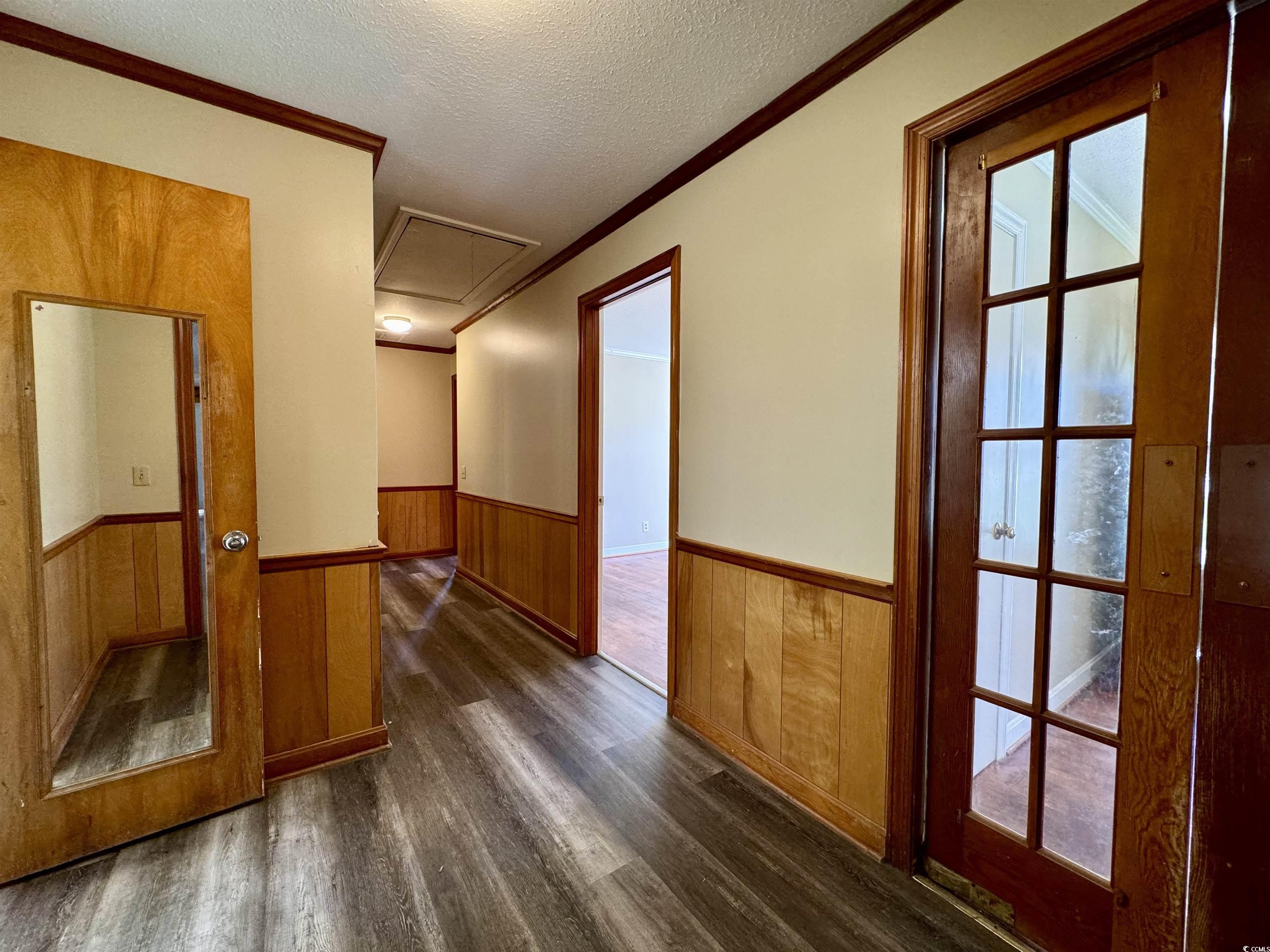 409 North Main Street Hemingway, SC 29554 - Photo 11 of 27 Hall with wood walls, dark wood-type flooring, a t