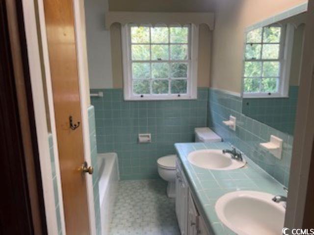 409 North Main Street Hemingway, SC 29554 - Photo 13 of 27 Bathroom with toilet, tile patterned flooring, a w