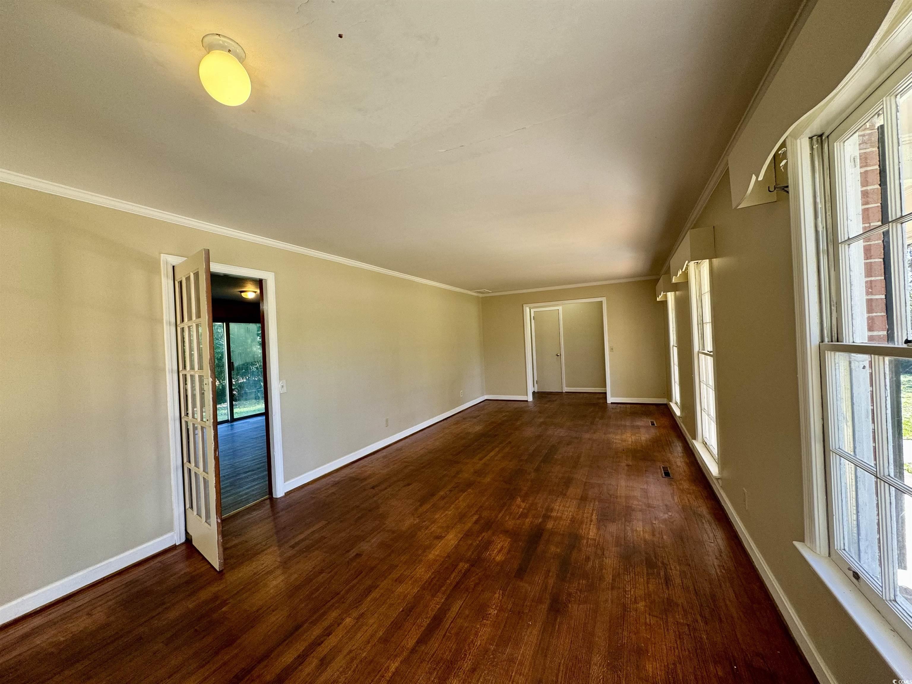409 North Main Street Hemingway, SC 29554 - Photo 7 of 27 Empty room featuring a wealth of natural light, fr
