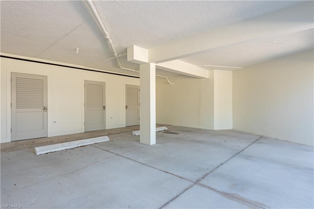 4155 Crayton Road, Unit 109 Naples, FL 34103 - Photo 13 of 21 Covered carport with secure storage next to unit