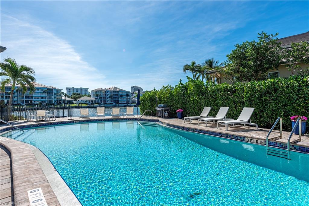 4155 Crayton Road, Unit 109 Naples, FL 34103 - Photo 16 of 21 View of pool featuring a patio area