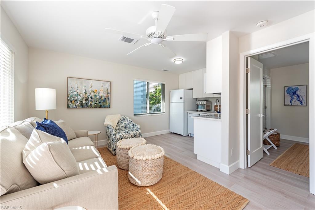 4155 Crayton Road, Unit 109 Naples, FL 34103 - Photo 20 of 21 Guest cottagbe Living room featuring light hardwood / wood-style floors, ceiling fan, and sink