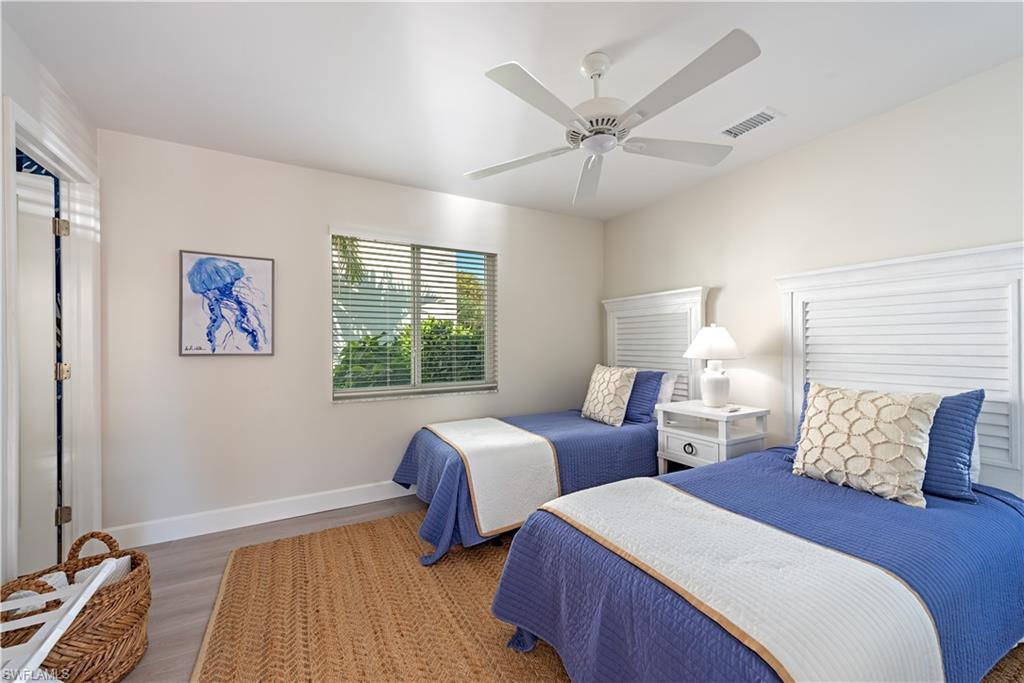 4155 Crayton Road, Unit 109 Naples, FL 34103 - Photo 21 of 21 Guest cottage Bedroom with dark hardwood / wood-style floors and ceiling fan