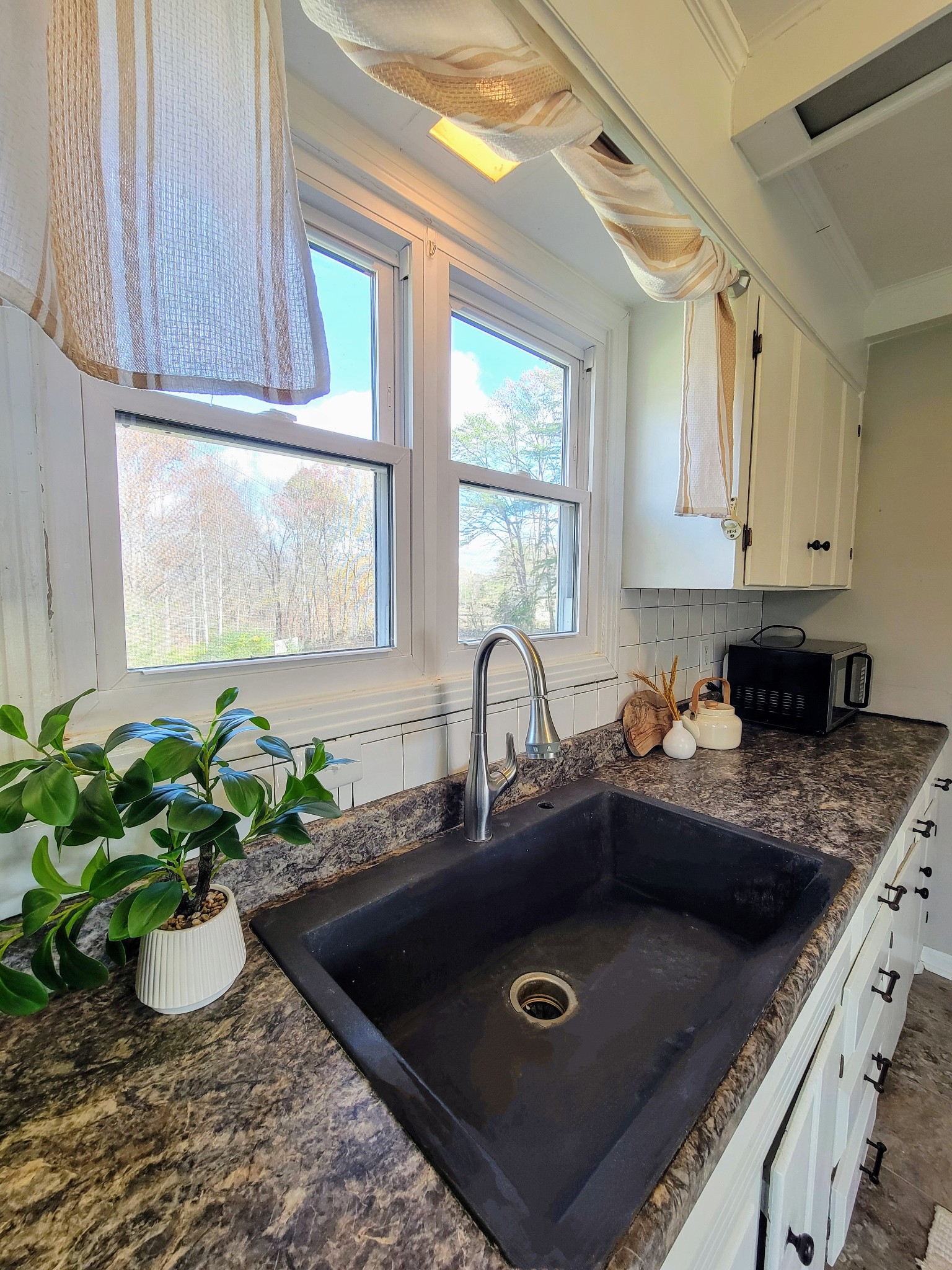 185 B Y Brown Road Charlotte, TN 37036 - Photo 28 of 52 a kitchen with a sink a window and potted plant