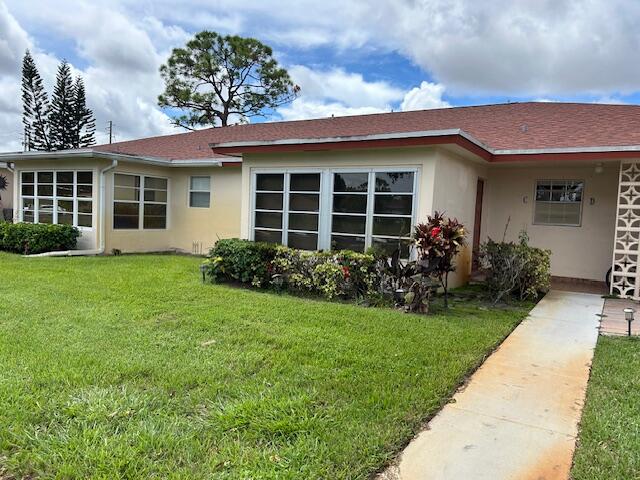 5265 Northwest 3rd Street, Unit C Delray Beach, FL 33445 - Photo 1 of 1 a front view of a house with a garden and plants