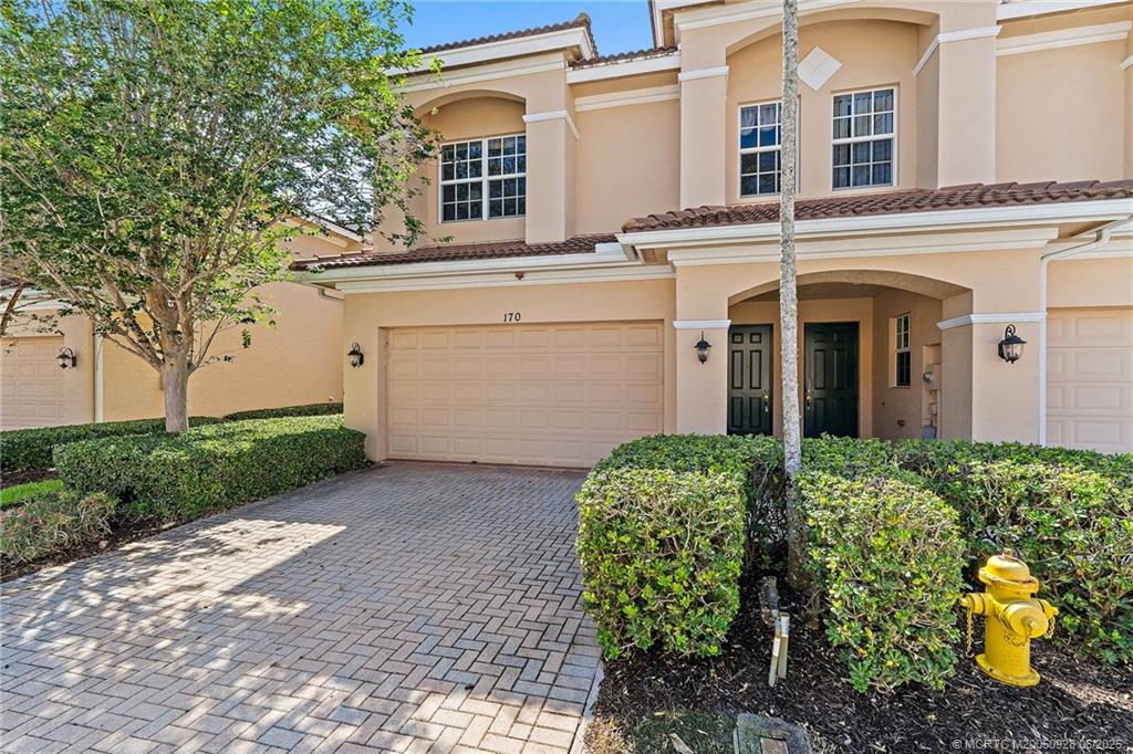 170 Southwest Walking Path Stuart, FL 34997 - Photo 1 of 18 a front view of a house with garden