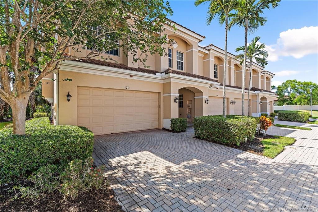 170 Southwest Walking Path Stuart, FL 34997 - Photo 2 of 18 a front view of a house with garden