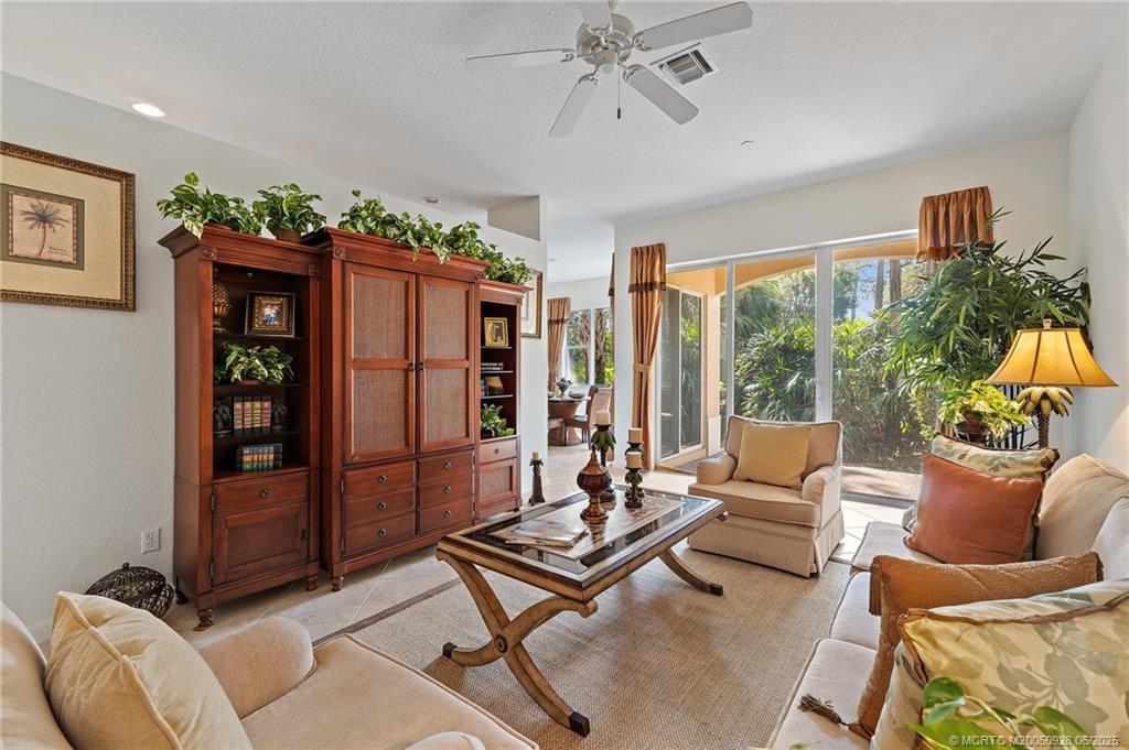 170 Southwest Walking Path Stuart, FL 34997 - Photo 3 of 18 a living room with furniture and a flat screen tv