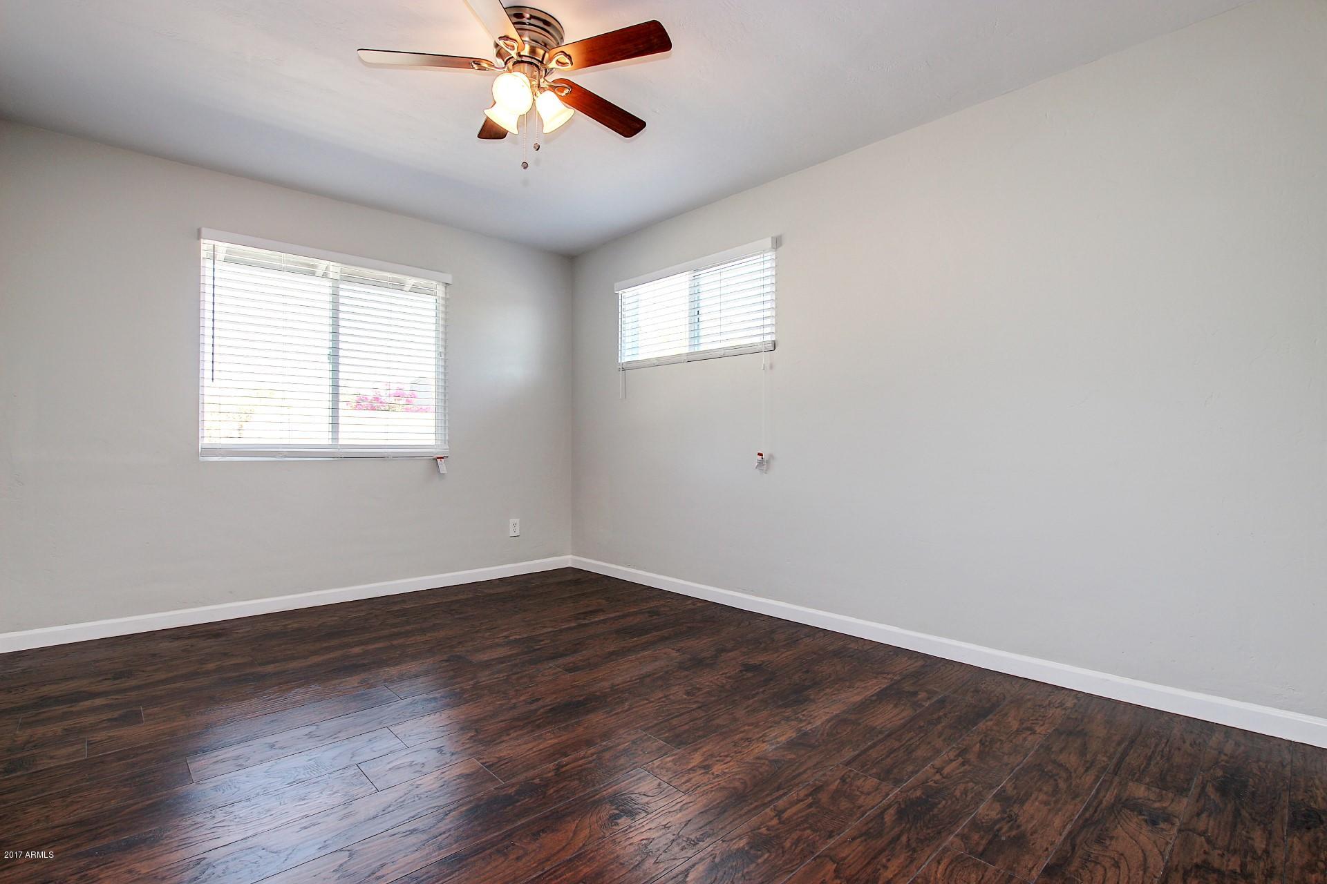 4844 East Coronado Road Phoenix, AZ 85008 - Photo 16 of 26 a view of a room with wooden floor and windows