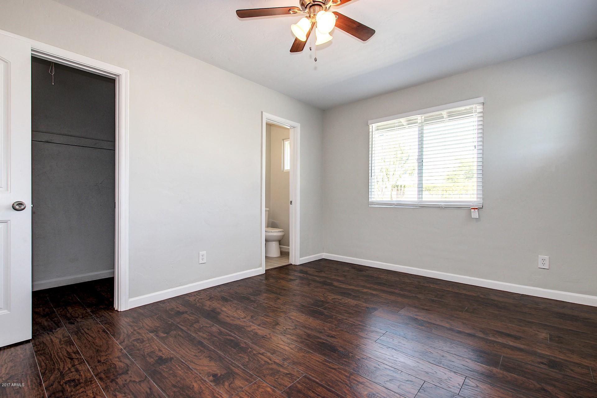4844 East Coronado Road Phoenix, AZ 85008 - Photo 17 of 26 a view of an empty room with wooden floor and a window