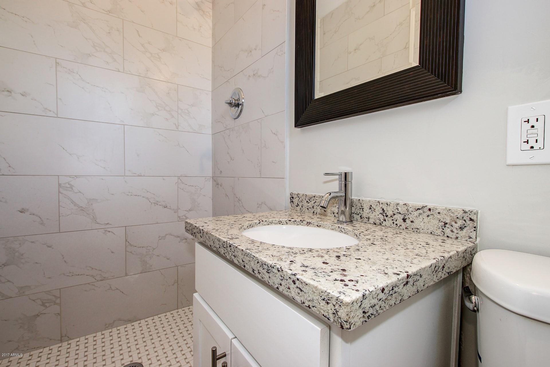4844 East Coronado Road Phoenix, AZ 85008 - Photo 19 of 26 a bathroom with a sink and a mirror