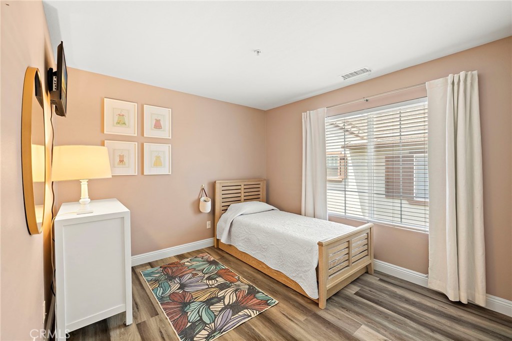 71 Sklar Street Ladera Ranch, CA 92694 - Photo 25 of 55 a bedroom with a bed and wooden floor