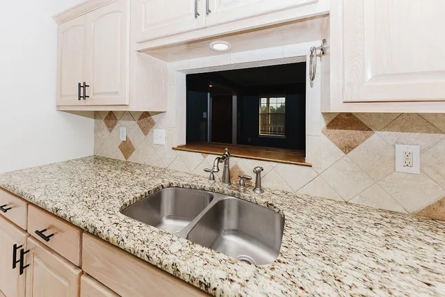 a bathroom with a granite countertop toilet sink and mirror